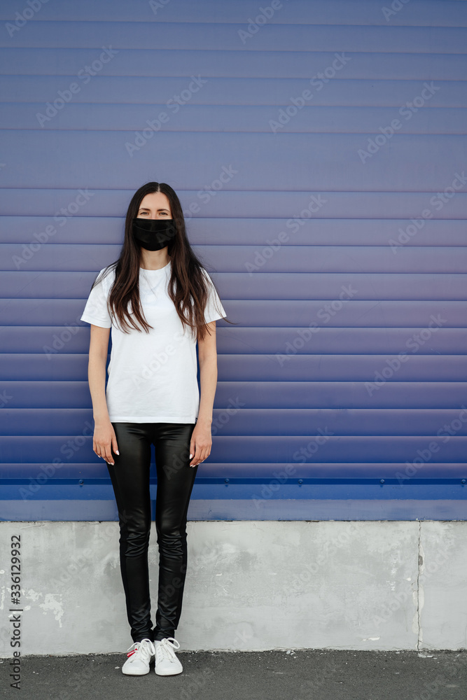 Woman wearing face mask because of Air pollution or virus epidemic in the city. Оn a blue background. Corona virus concept. Woman wearing face mask because of Air pollution or virus epidemic in the city. Оn a blue background. Corona virus concept.