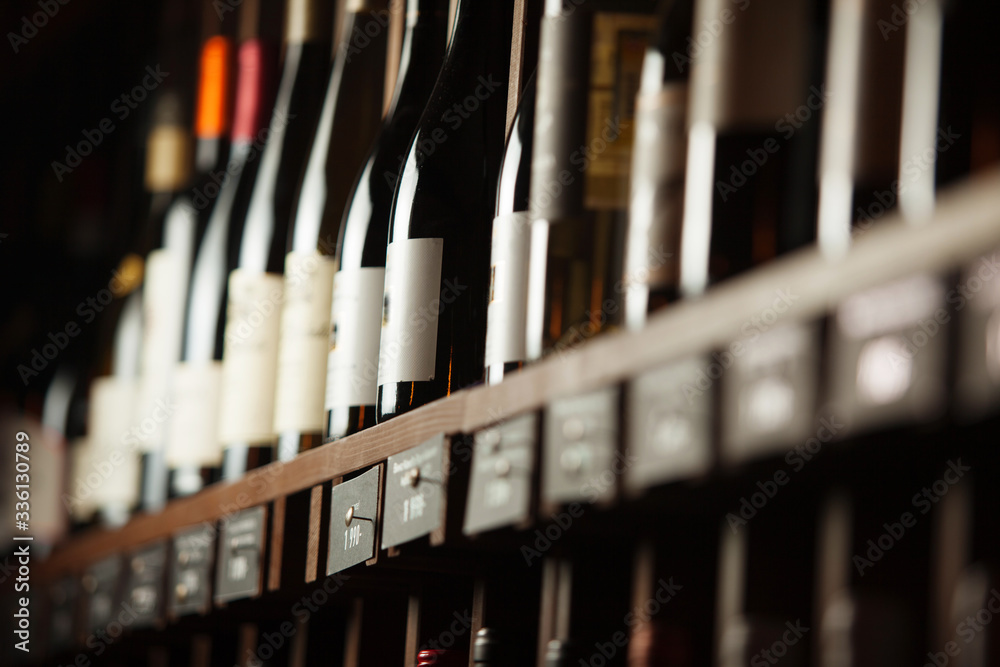 Wine cellar with elite drinks on shelves with written names Wine cellar with elite drinks on shelves with written names