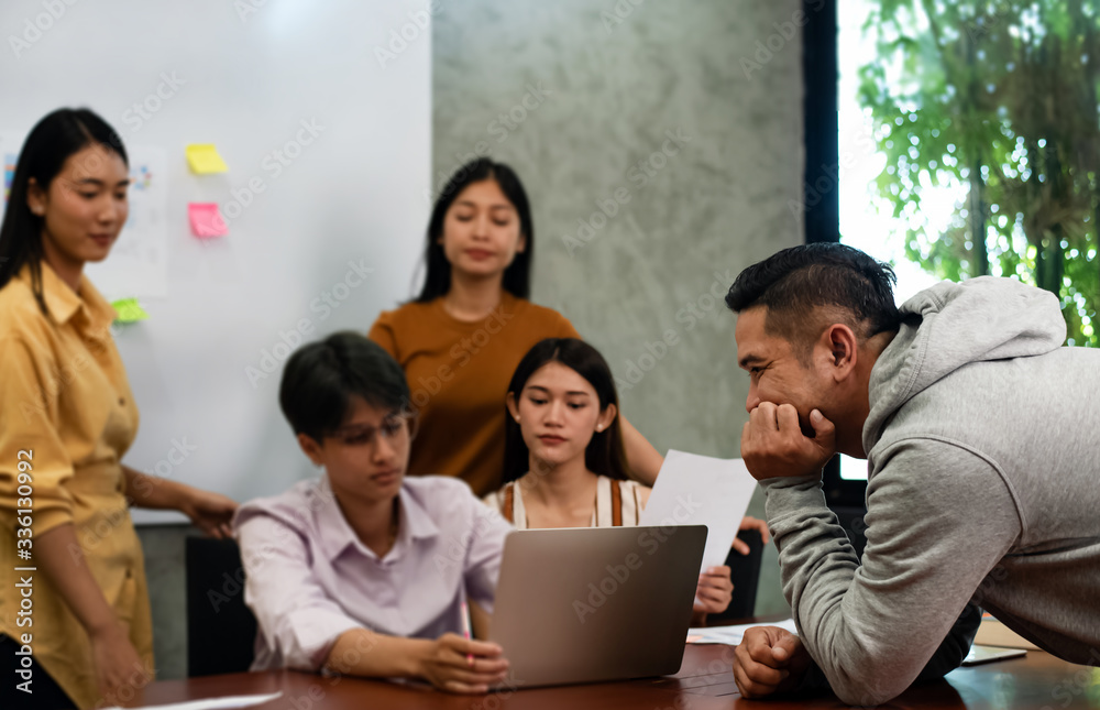 In selective focus of Handsome man talking with Young business people working ,with colleagues team meeting, In selective focus of Handsome man talking with Young business people working ,with colleagues team meeting,