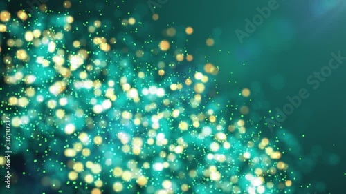 Green shiny sparkling particles move. It is bright festive background with glittering particles depth of field bokeh 