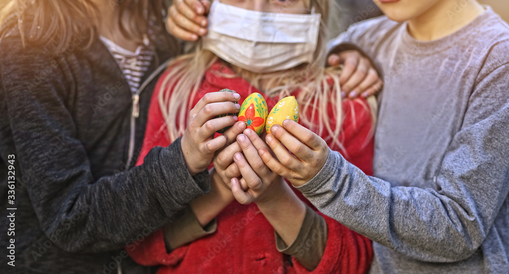 kids in masks hold an Easter egg