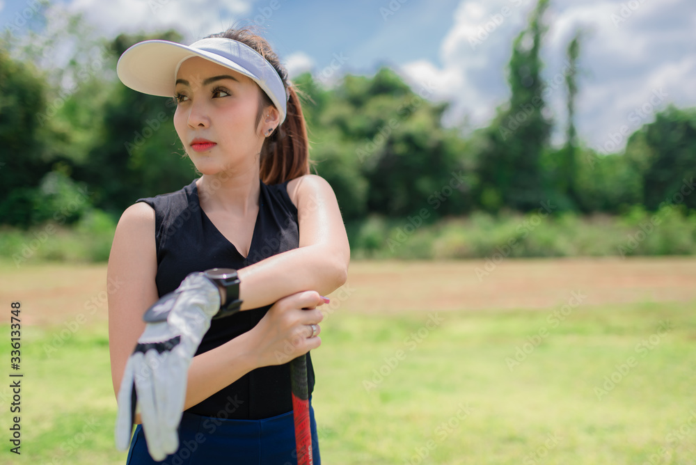 Portrait of golfer asian woman holding golf wood at the country club,Happy woman concept Portrait of golfer asian woman holding golf wood at the country club,Happy woman concept
