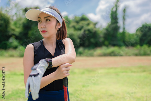 Portrait of golfer asian woman holding golf wood at the country club,Happy woman concept