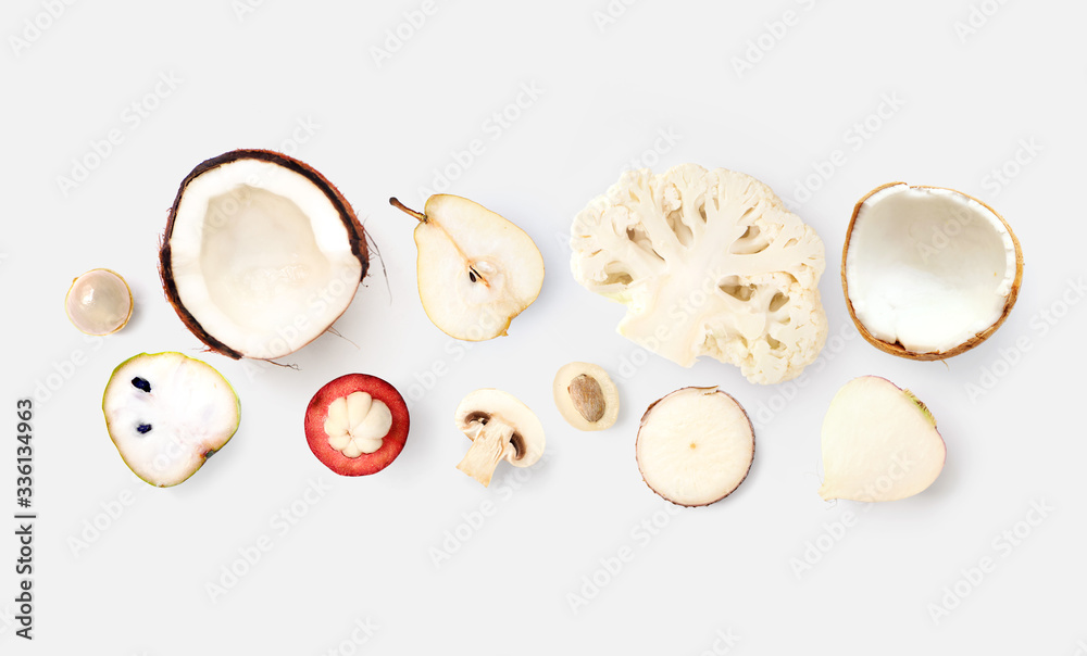 Creative layout made of mangosteen, coconut, cauliflower, cherimoya, pear, champignon, rambutan, cassava  on the white background. Flat lay. Food concept. Macro  concept.