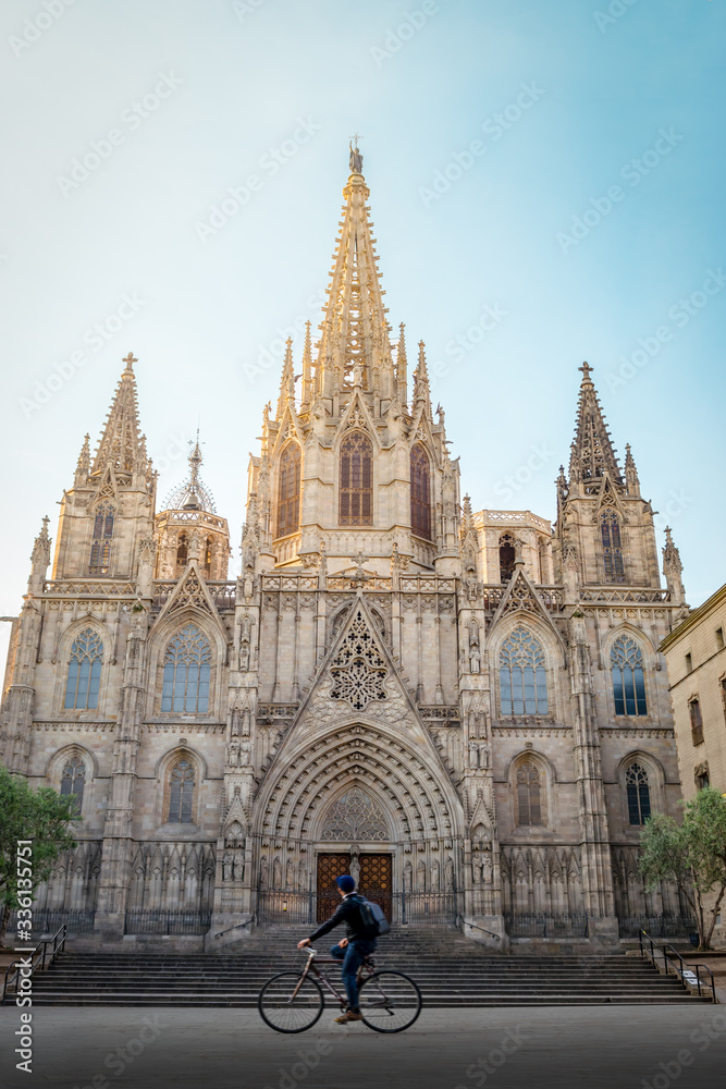 Gothic cathedral of Barcelona with a cyclist
