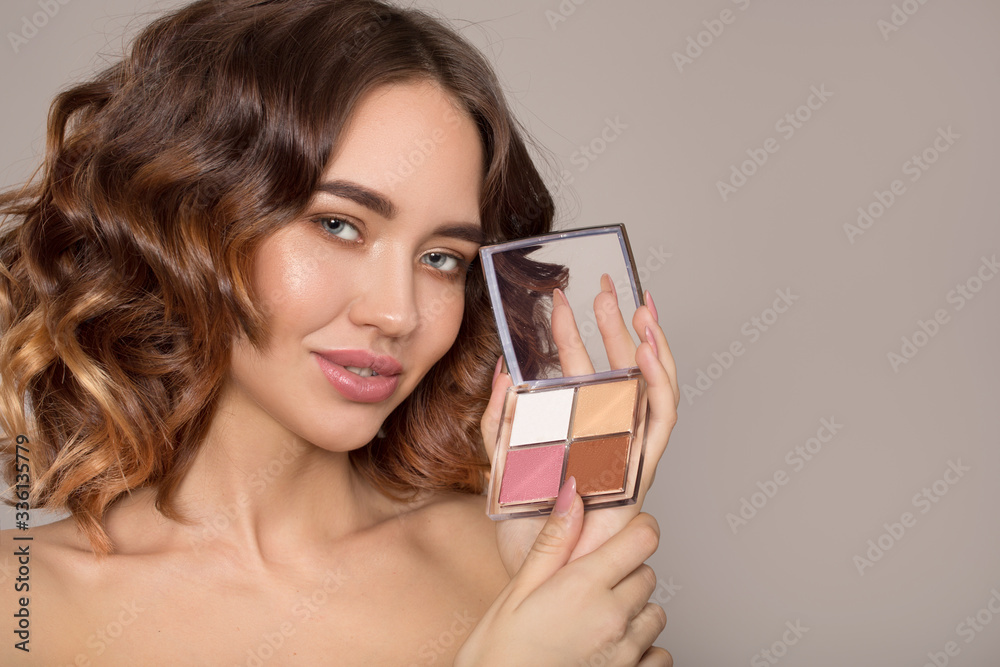 Portrait of a beautiful young woman with makeup on a gray background. Face close up. copycpase Portrait of a beautiful young woman with makeup on a gray background. Face close up. copycpase