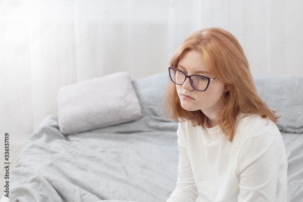 sad teenager girl in glasses on bed sad teenager girl in glasses on bed