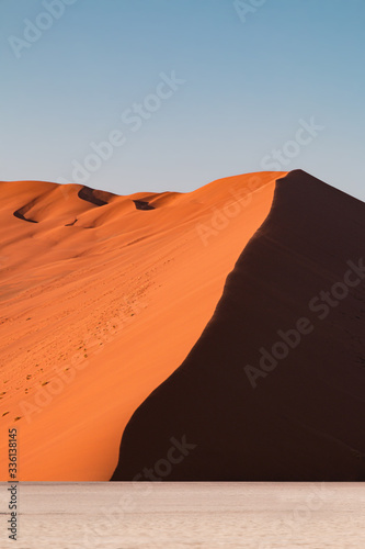 Orange desert dune lateral view at sunrise, Namib Naukluft National Park, Sesriem, Namibia, Africa photo