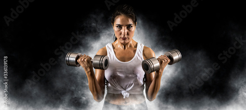 Woman working out with dumbbell