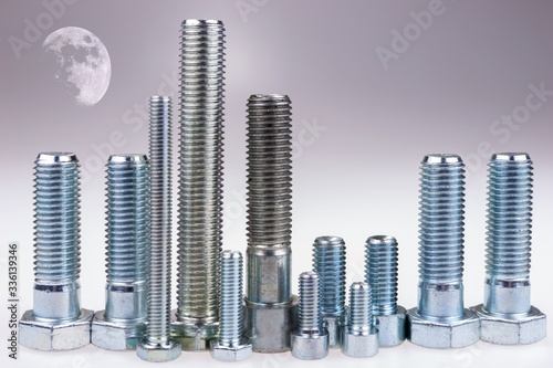 Night city with bright moon. Bolts standing like a skyline. City made with bolts