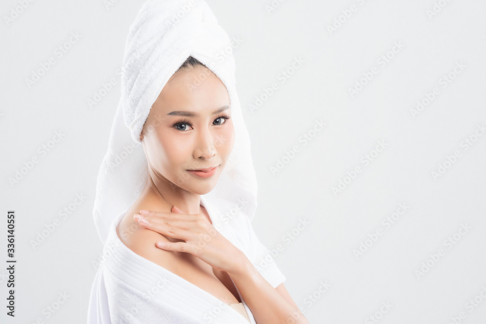 Woman in bathrobe with towel with towel on head. Woman in bathrobe with towel with towel on head.