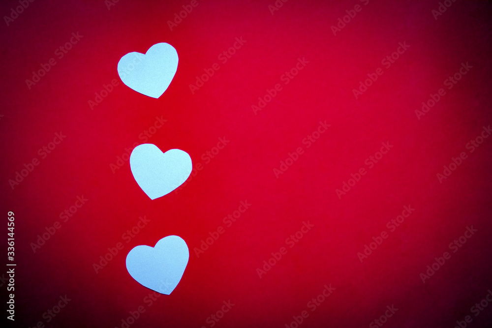 Cardboard hearts on red background