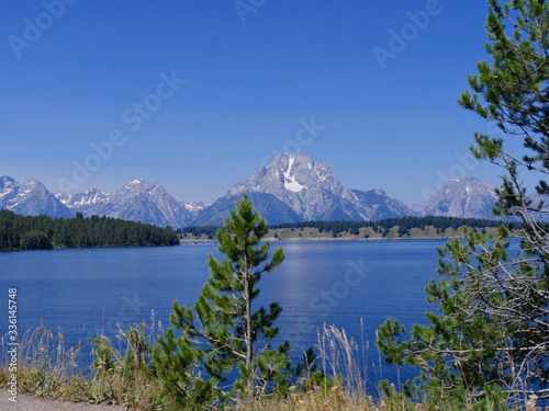 Scenic view of Jackson Lake dam with the Grand Teton mountain ranges in the background.
