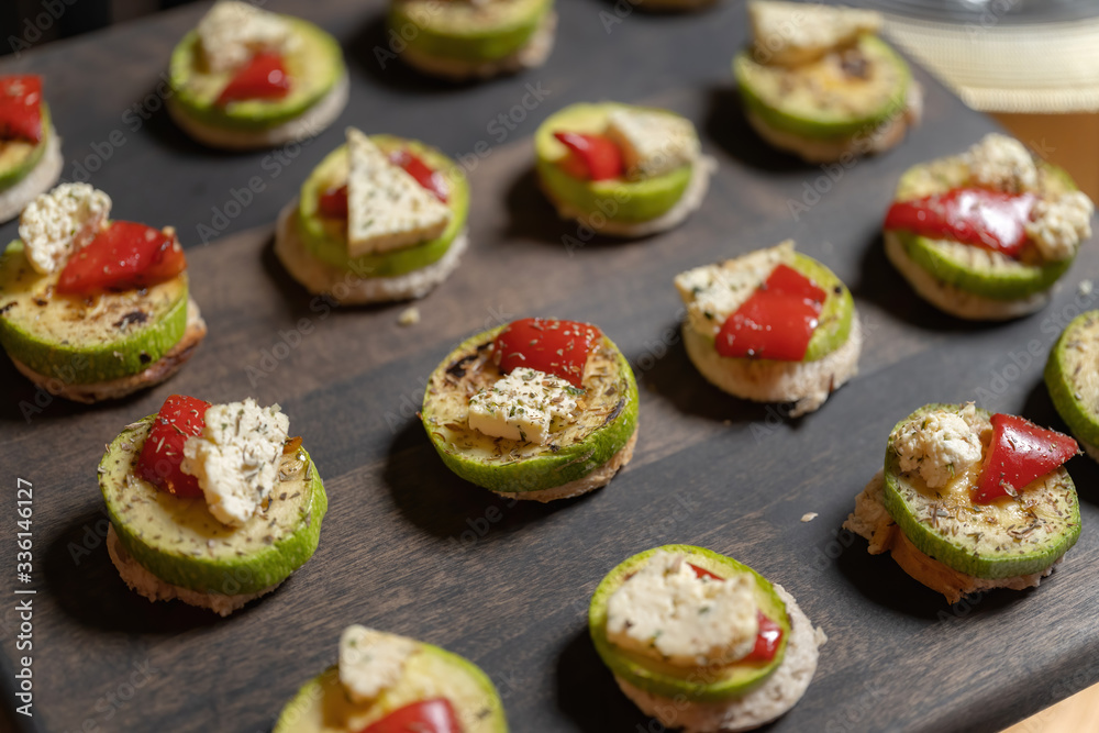 Zucchini with cheese, tomatoes and spices. A lot has been laid out on the board. Zucchini with cheese, tomatoes and spices. A lot has been laid out on the board.