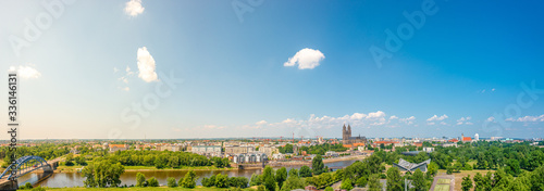 Panoramic bird view of Elbe river, old and new town, cathedral and city park in Magdeburg, Germany, summer, blue sky