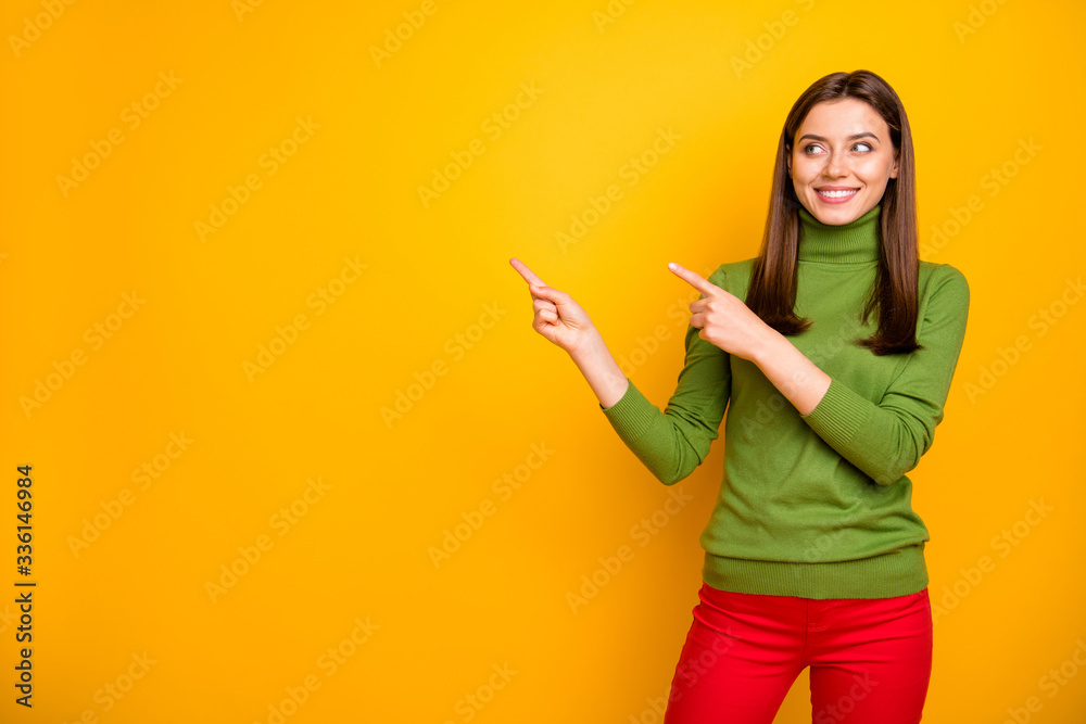 Portrait of cheerful positive girl point index finger present sales discounts suggest promotion wear stylish good looking outfit isolated over yellow color background Portrait of cheerful positive girl point index finger present sales discounts suggest promotion wear stylish good looking outfit isolated over yellow color background