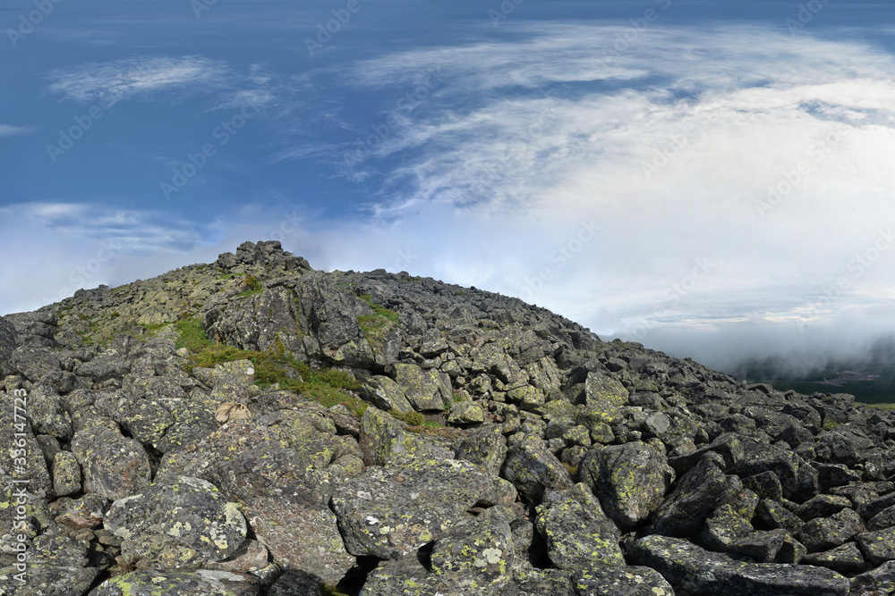 Ural mountains in the northern ridge. Rocky hillside, mosses and rare plants under the bright sun. Ural mountains in the northern ridge. Rocky hillside, mosses and rare plants under the bright sun.