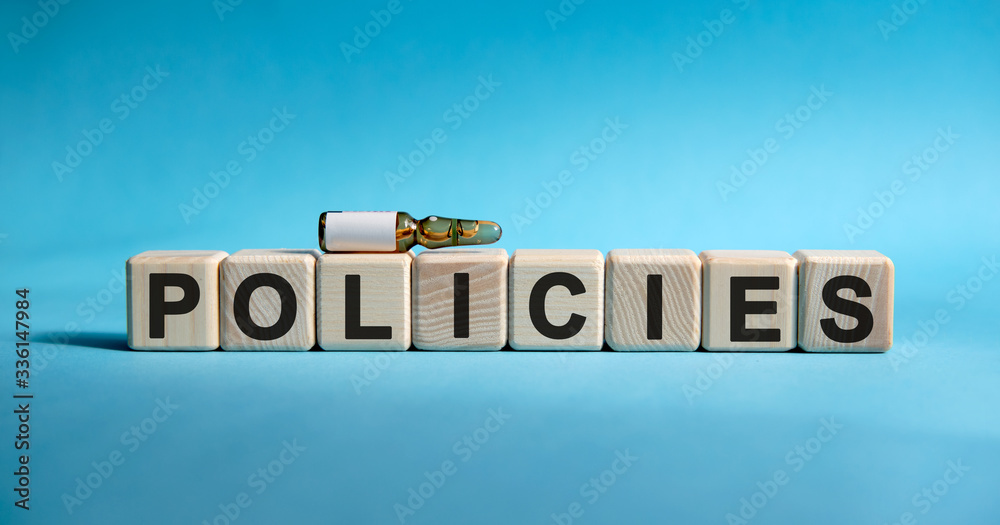 POLICIES - text on cubes. Drug in ambula to reduce disease symptoms on a blue background POLICIES - text on cubes. Drug in ambula to reduce disease symptoms on a blue background