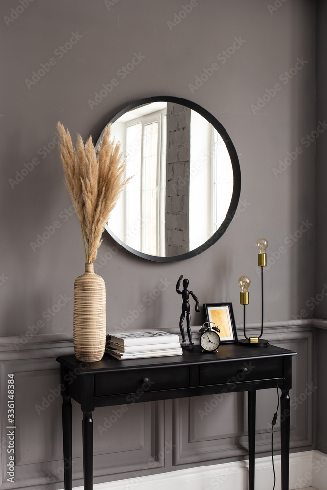 custom made wallpaper toronto digitalConsole with a mirror on a background of a gray wall in a modern interior.