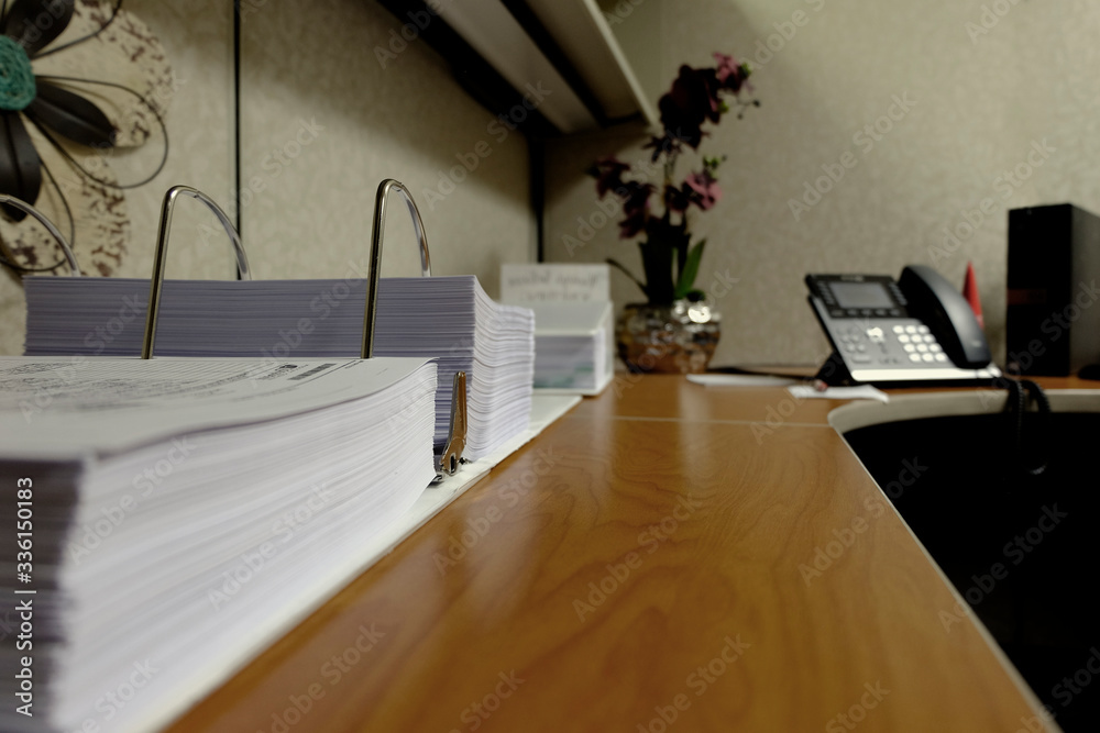 Office Workspace Desk with Binder and Phone