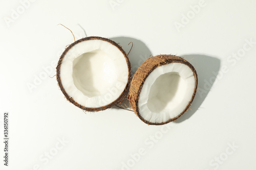 Halves of coconut on white background, top view