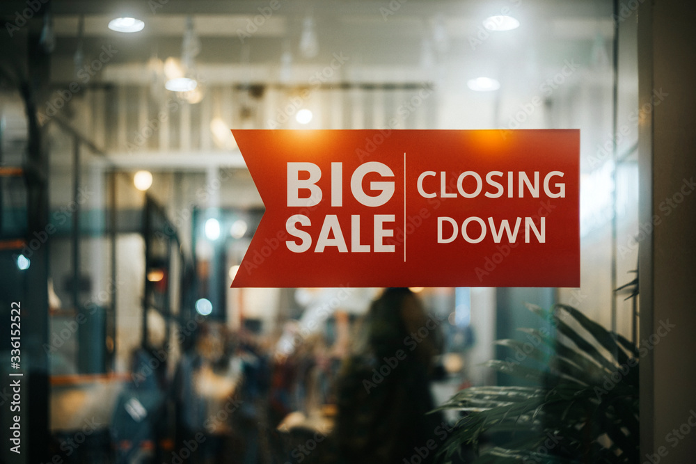 Big sale Closing Down  sign painted on the window of a dress shop. - obrazy, fototapety, plakaty 
