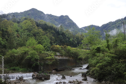 Beautiful landscape of a river in the mountain between trees 