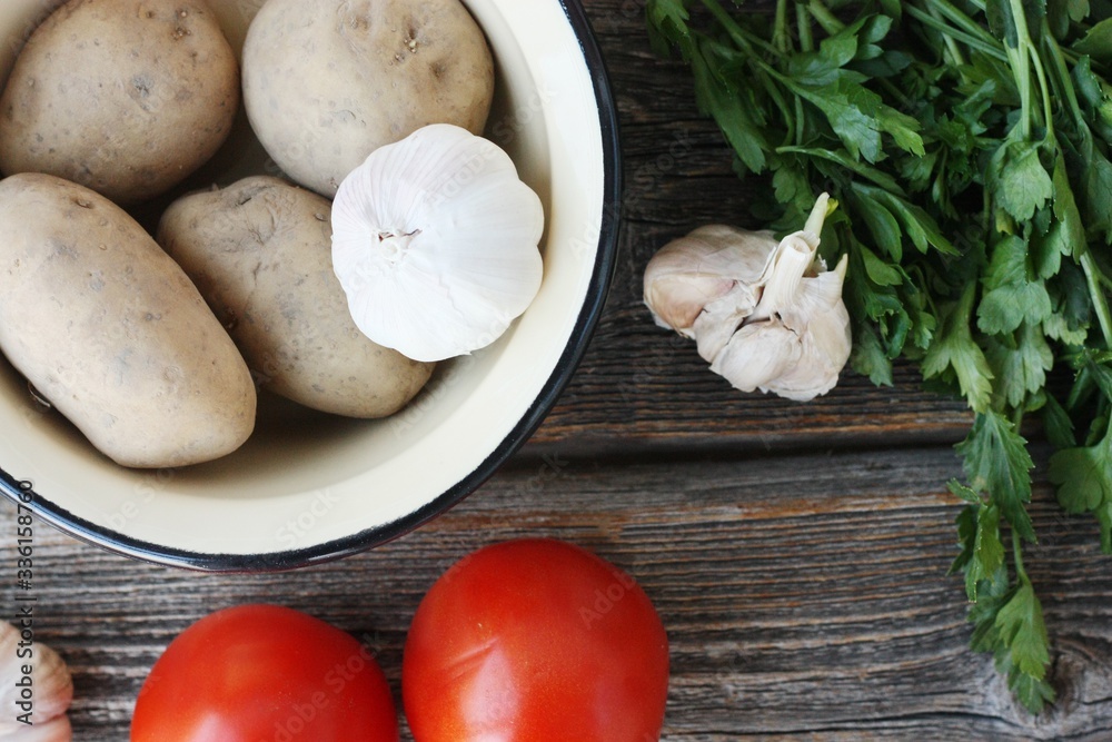 Tomatoes potatoes and garlic on the table Tomatoes potatoes and garlic on the table