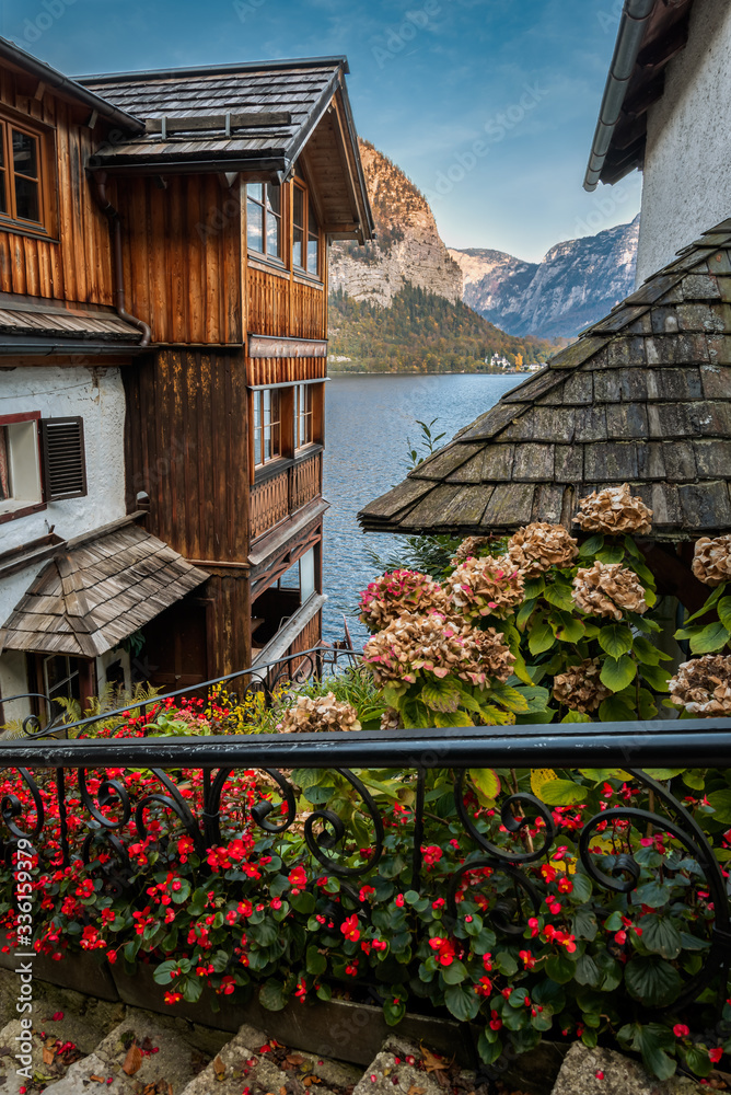 View of the mountains and the Hallstatt Lake looking through between the traditional houses of Hallstatt, Austria