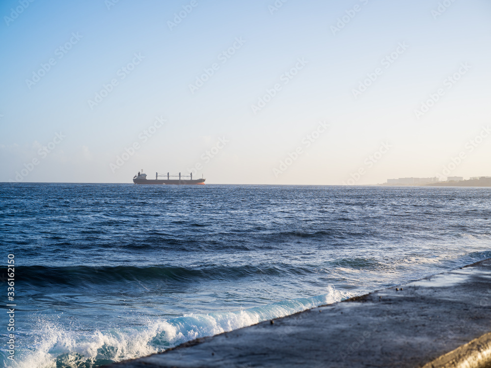 Cargo ship in the horizon arriving in Havana, cuba Cargo ship in the horizon arriving in Havana, cuba