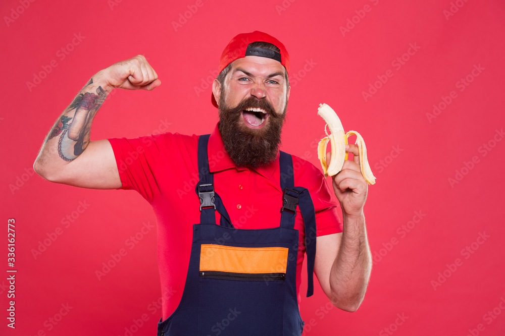 mens power and health. erect banana as concept of treating impotence. healthy break concept. brutal strong male in cap and uniform eat banana. healthy lunch snack. mature man builder feel hunger mens power and health. erect banana as concept of treating impotence. healthy break concept. brutal strong male in cap and uniform eat banana. healthy lunch snack. mature man builder feel hunger