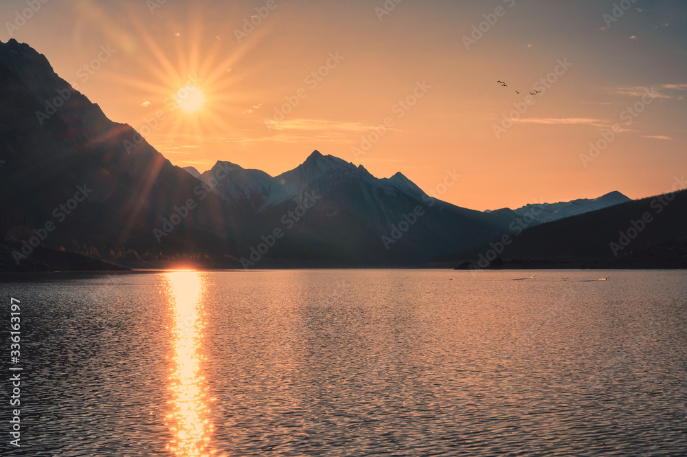 Sunrise on Canadian rockies with colorful sky on Medicine Lake at Jasper national park