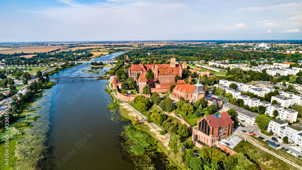 Obraz premium The Castle of the Teutonic Order in Malbork on the bank of the Nogat River. UNESCO world heritage in Poland