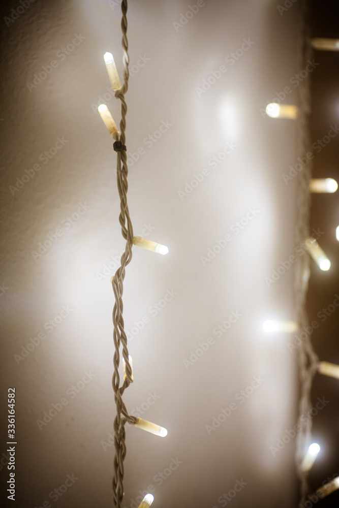 White electric garland. Holiday lights. Beautiful background with LED garland at night