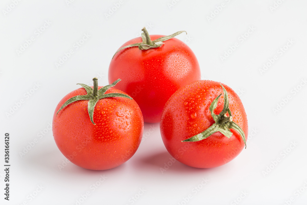 Beautiful juicy red tomatoes on a white background Beautiful juicy red tomatoes on a white background