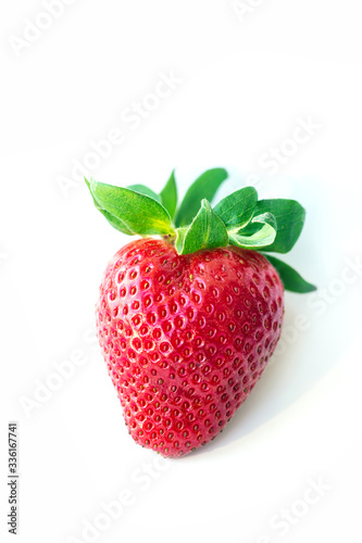 One fresh strawberry were placed on a white background. Copy space
