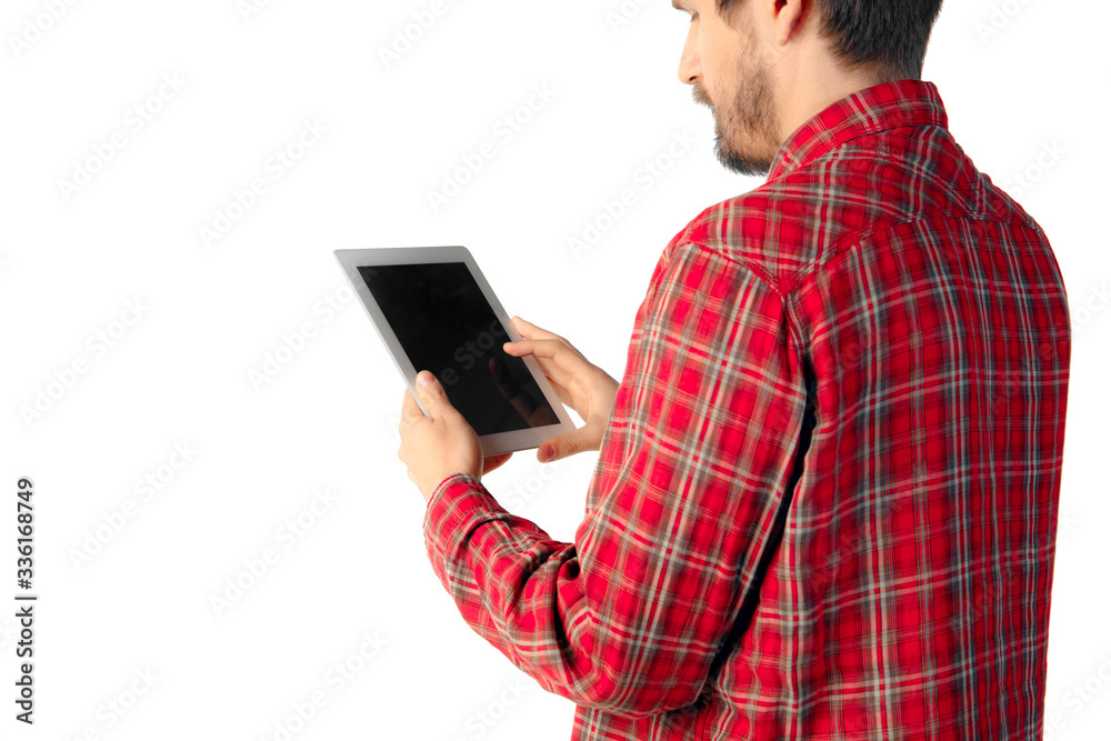 Close up shoot of young caucasian man using tablet with blank screen isolated on white studio background. Concept of modern technologies, gadgets, tech, emotions, advertising. Copyspace. Close up shoot of young caucasian man using tablet with blank screen isolated on white studio background. Concept of modern technologies, gadgets, tech, emotions, advertising. Copyspace.