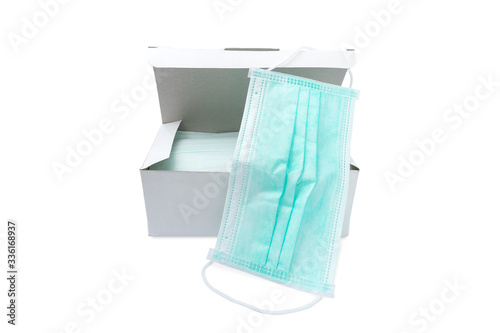Pack of ear loop medical masks in box with medical mask on top isolated on white background with clipping path. anti virus and bacteria protective face air pollution, environmental concept.
