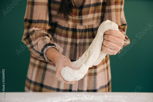 Woman prepares to her home handmade dough for bread, homemade cooking.