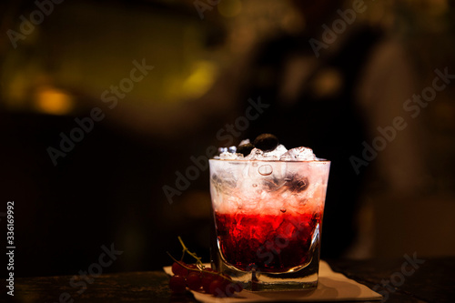 Mixed by bartender in cocktail bar gin based fruity bramble drink
