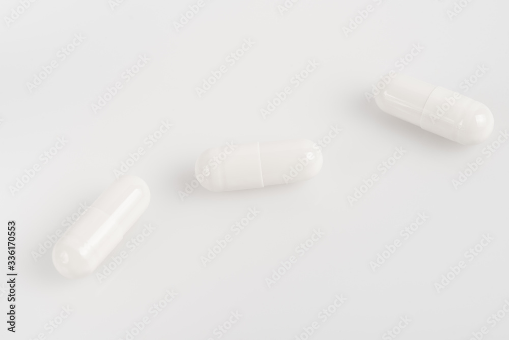 white pills on a white background white pills on a white background