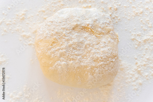 Handmade dough for bread on a white marble background, homemade cooking.