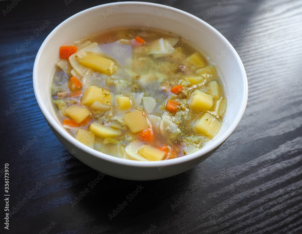 Soup in a white plate of broccoli, carrots, potatoes and square gluten-free pasta . Entree Soup in a white plate of broccoli, carrots, potatoes and square gluten-free pasta . Entree
