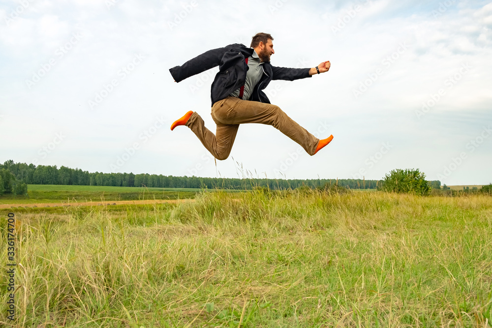 a man with a beard running high above the ground almost flies a man with a beard running high above the ground almost flies