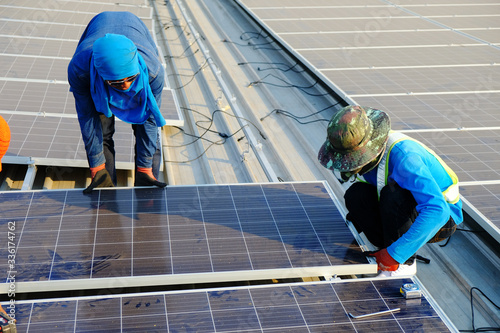 PHETCHAIBUN - THAILAND, February 22, 2020 ; Solar panel technician installing solar panels on roof. Alternative energy ecological concept.