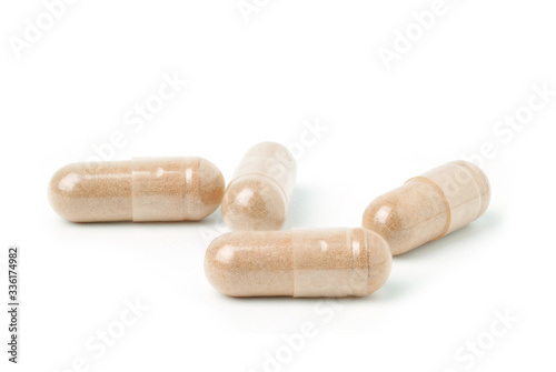 capsules of Finely ground dry Turmeric isolated on white background.