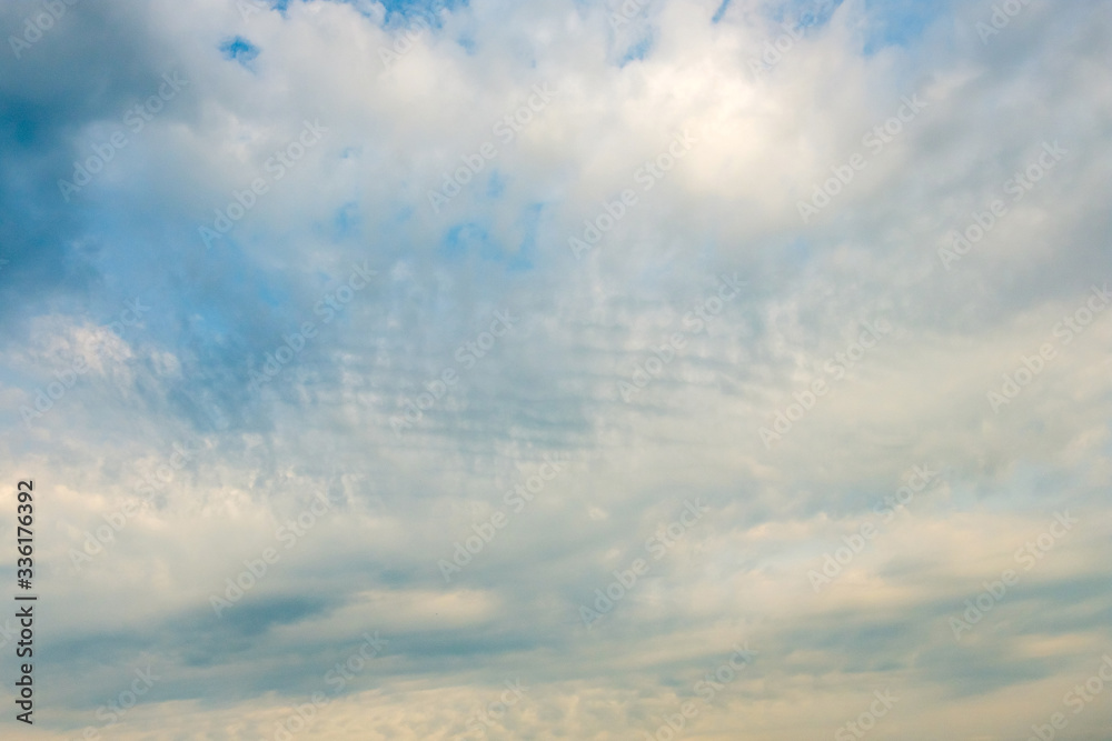 sky with cumulus clouds and small ripples