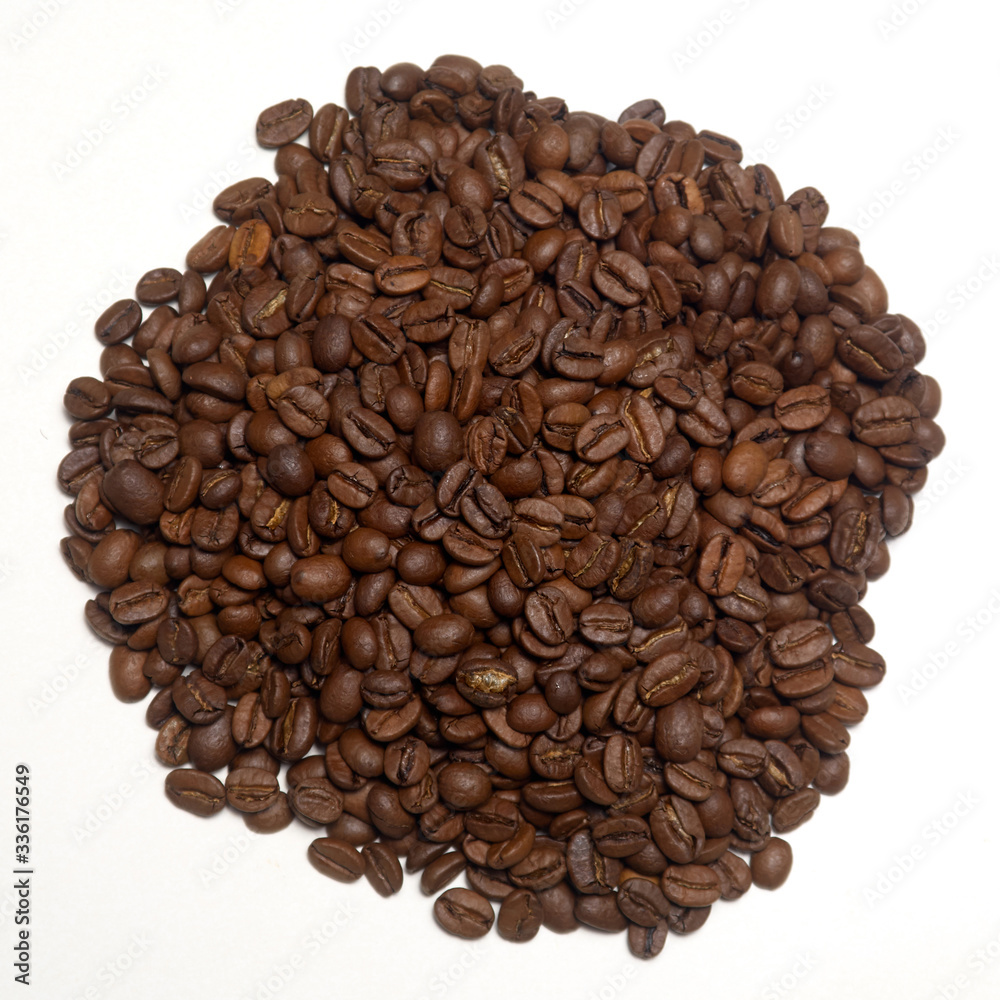 Pile of roasted coffee beans over white background Pile of roasted coffee beans over white background