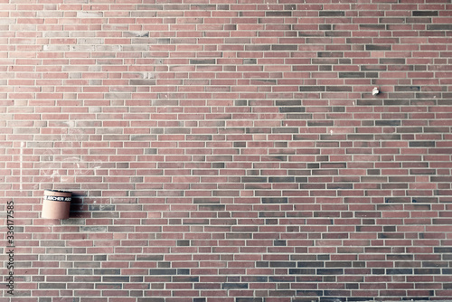 dustbin on brick wall