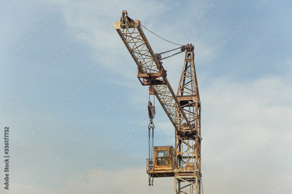 old abandoned soviet rusty crane with tower on sky background old abandoned soviet rusty crane with tower on sky background